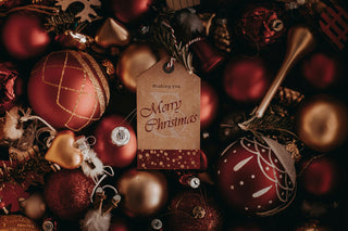 Decorative Christmas ornaments with a 'Merry Christmas' tag in the center.